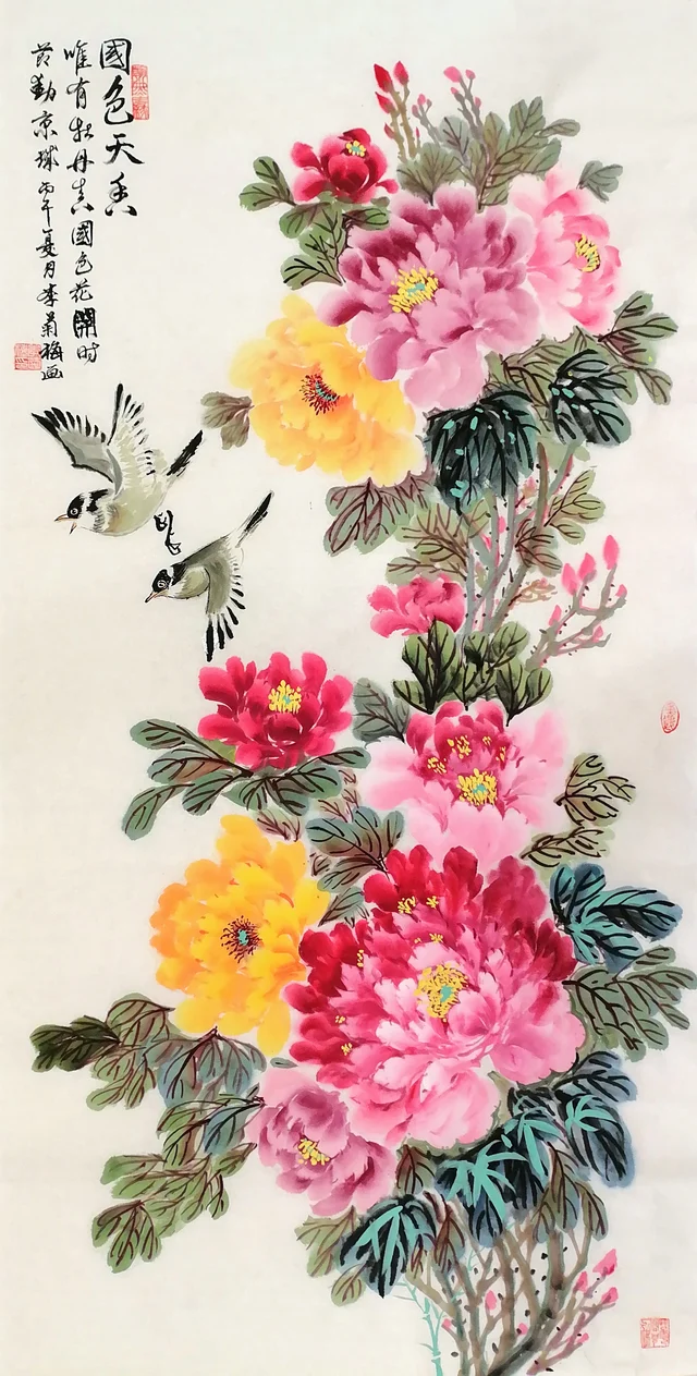 A tall painting of red, pink and golden-yellow peonies climbing from the lower right to the top, two small birds flying in at the upper left, and three columns of calligraphy beside them.