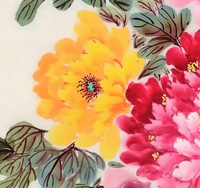 A golden peony beside a crimson one.