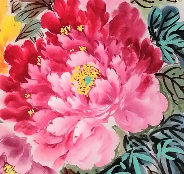 A full peony, deep at the base of the petals and pale at the edges.