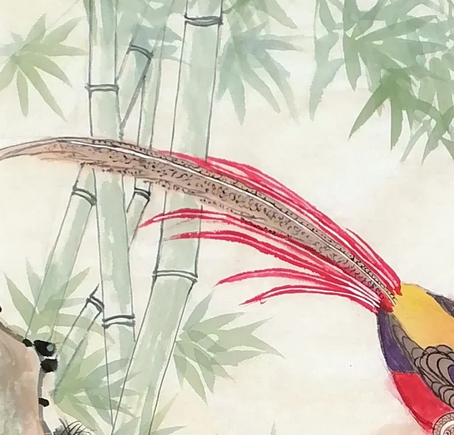 The long tail trailing past stems of bamboo.