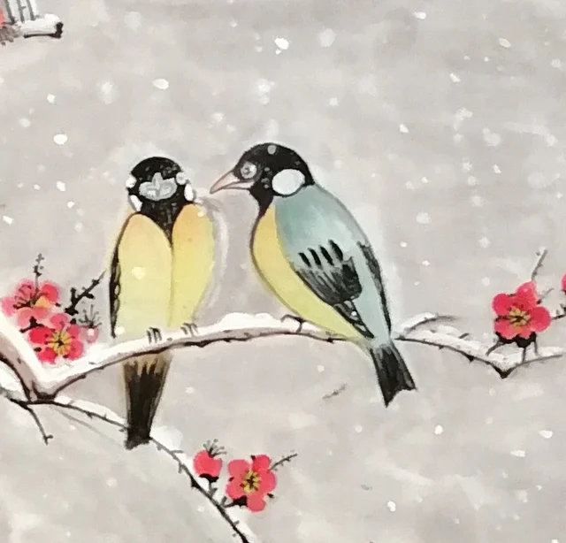Two tits side by side on a snowy bough.