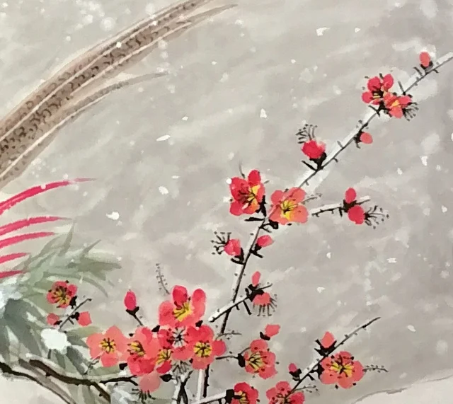 A spray of red plum, its twigs edged with snow.