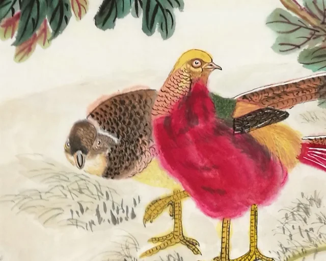 The pair of golden pheasants on the bank.