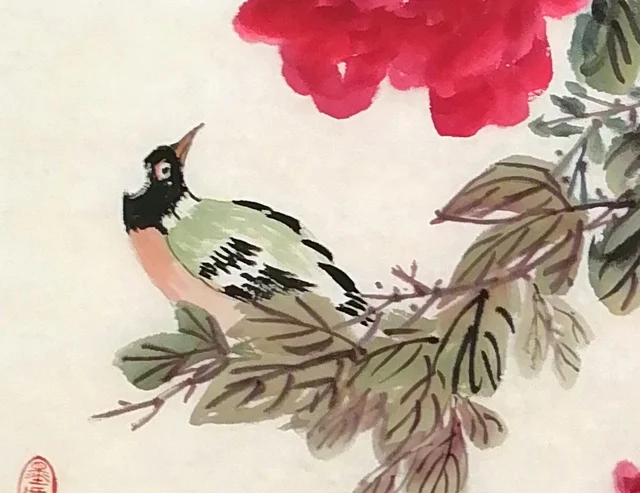 A bulbul perched among the branches, looking back.