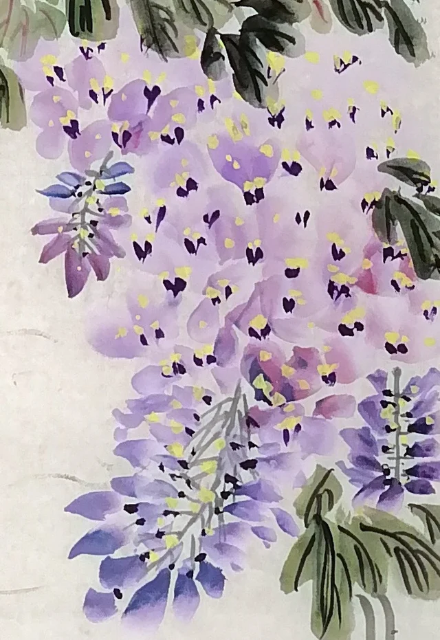 Hanging blossoms, with petals fallen on the water.