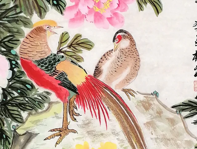 The pair of golden pheasants, face to face.
