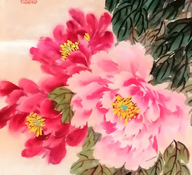 A large pink peony leaning against a deep red one.