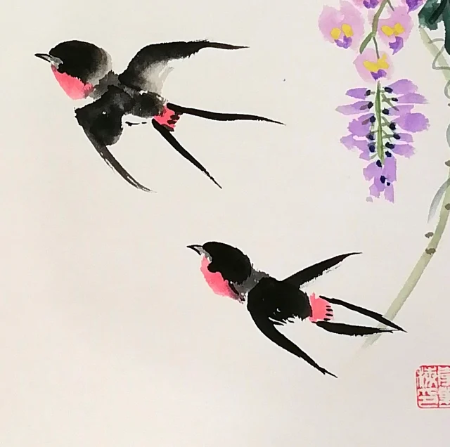 A pair of swallows in flight.