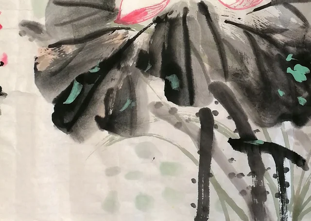 Dark ink lotus leaves dotted with green.