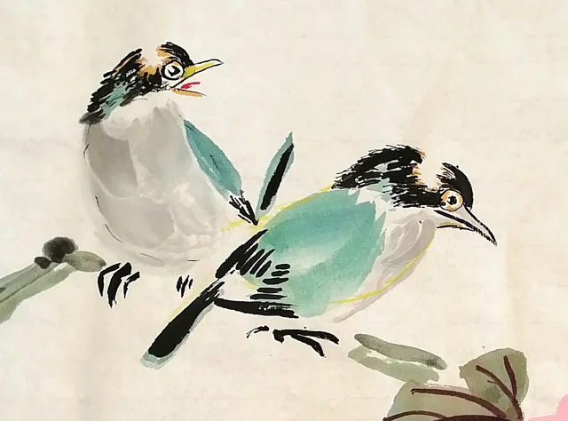 The pair of bulbuls on the bare branch.
