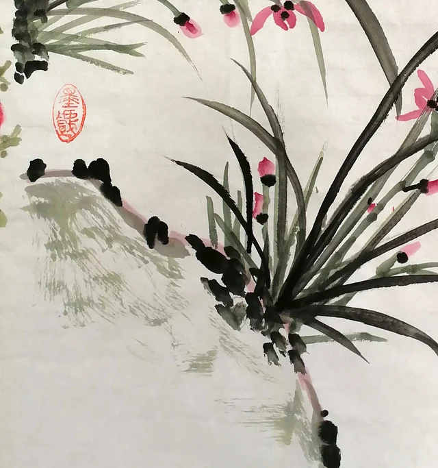 Long orchid leaves and the mossy bank.