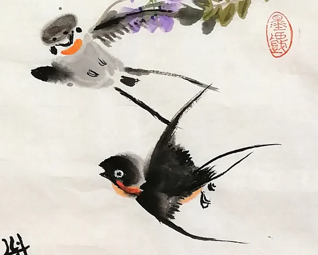 Two birds flying through the flowers.
