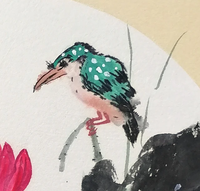 The kingfisher, its feathers spotted white.