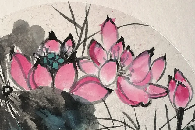 Two pink lotuses, rouge at the petal tips.