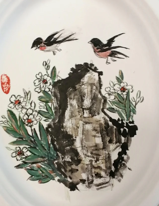 The ink rock, white flowers and the two swallows.