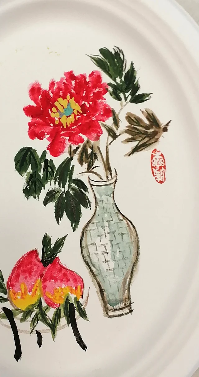The peony in a celadon vase and two peaches.