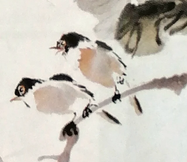 Two small birds on an old branch.