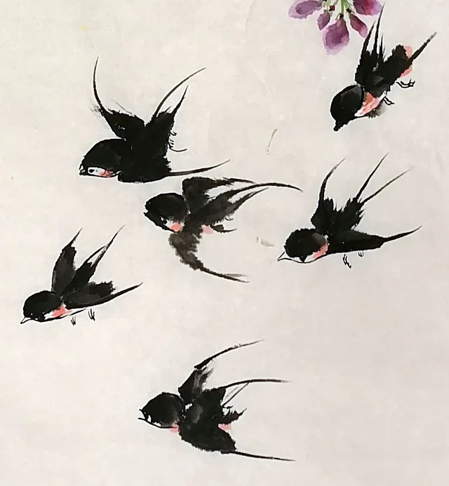 Six swallows flying in a loose band.