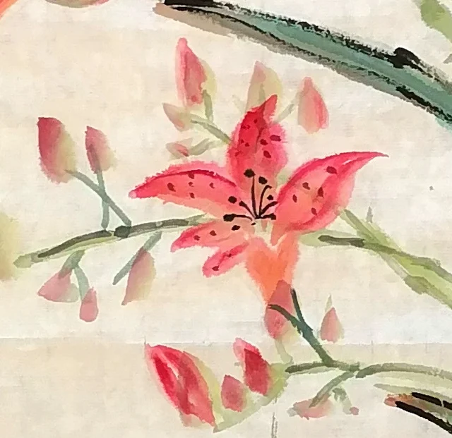 A vermilion flower with an orange heart.
