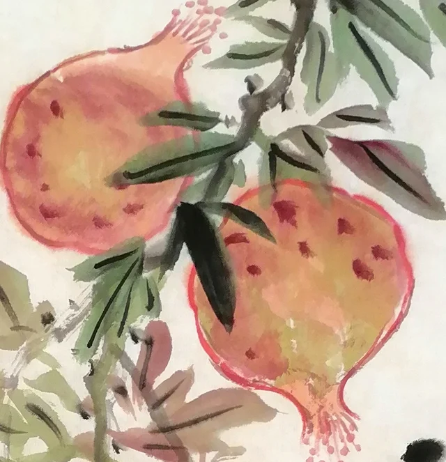 Two pomegranates at the top.