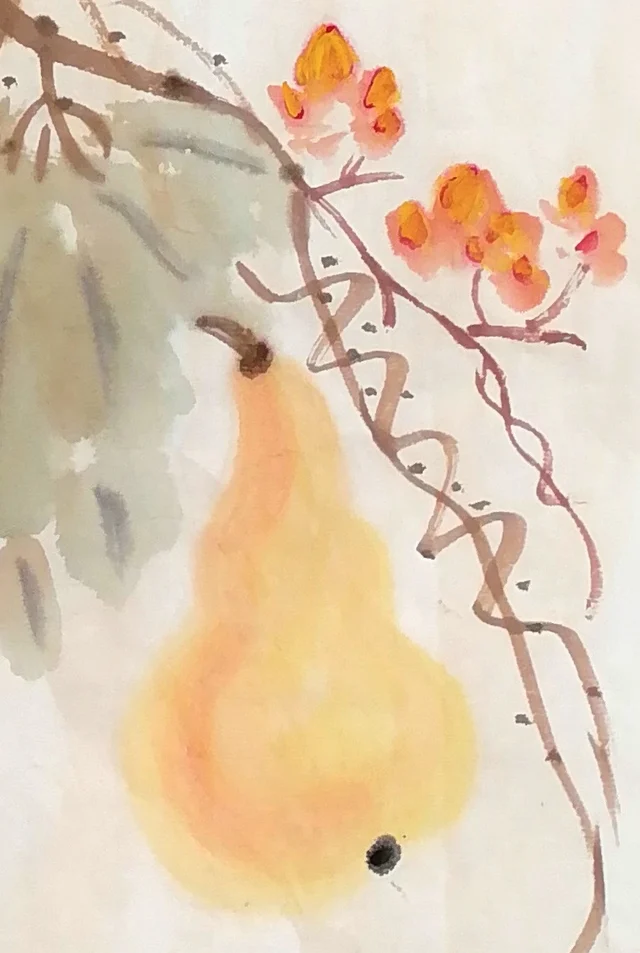 The single gourd below, beside small orange flowers.