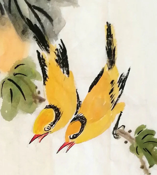 The golden orioles, red beaks open.