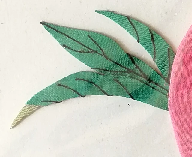 Leaves of green cloth with veins drawn in ink.