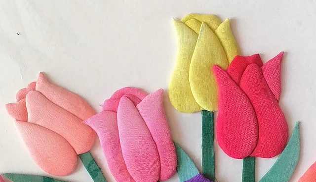 Pink, yellow and scarlet blooms, each petal cut and padded separately.