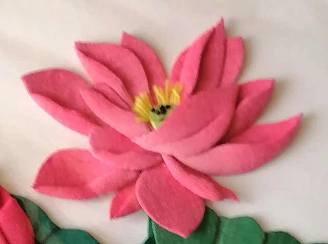 The lotus, layered pink petals around a yellow heart.