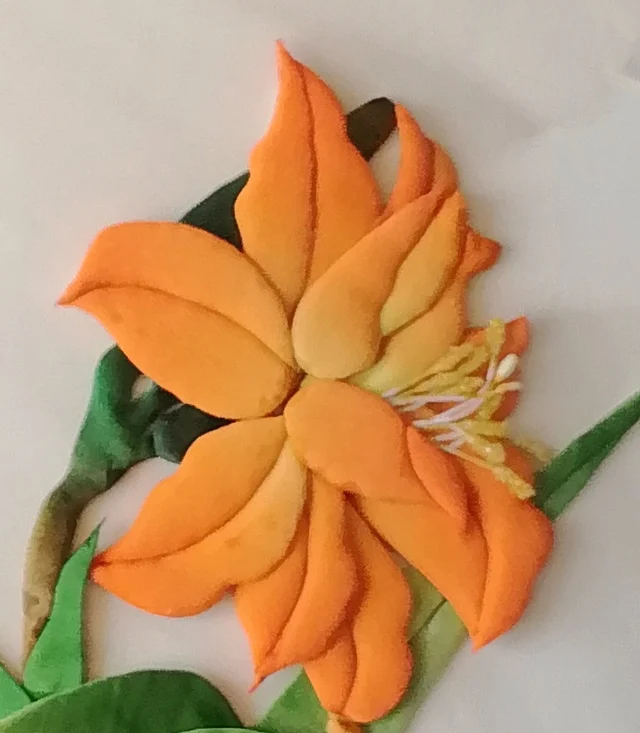 The orange lily, its petals gathered in layers.