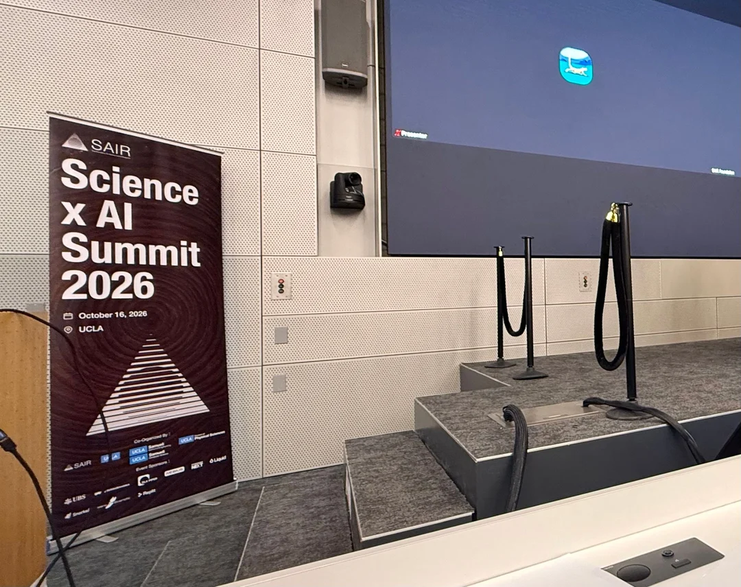 The Science x AI Summit 2026 banner beside the stage of a lecture hall at UCLA, 16 October 2026.